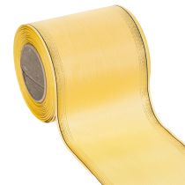 Itens Fita decorativa em moiré amarela com borda dourada, 100 mm de largura, 25 m de comprimento, ideal para arranjos florais e decoração.