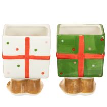 Itens Vaso de cerâmica para decoração natalina, com design de presente e pés delicados.