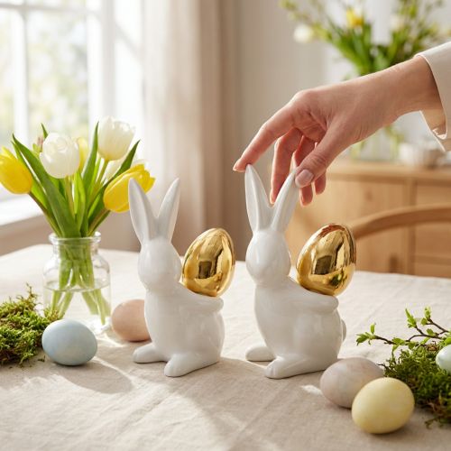 Coelhos com ovo de ouro, coelhos de cerâmica para Páscoa nobre branco, dourado H13cm 2pcs | Floristik24.pt