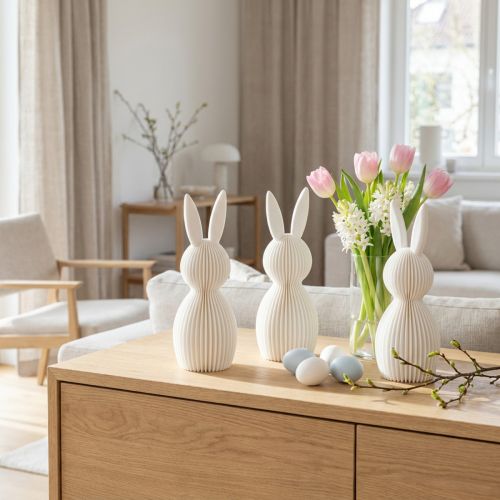Conjunto de 3 peças com 13 cm de comprimento, composto por uma estatueta decorativa de coelho com um visual plissado, ideal para decoração de interiores moderna, sala de estar ou escritório. | Floristik24.pt
