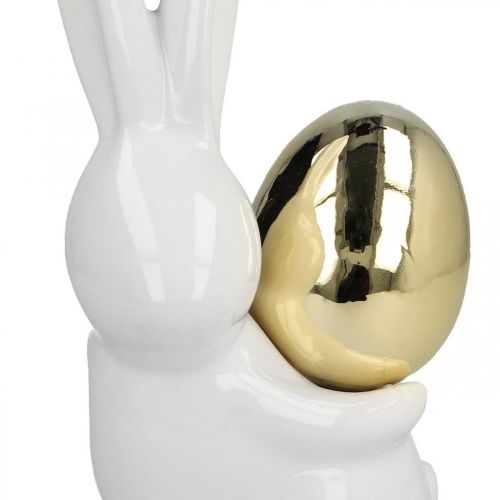 Floristik24 Coelhinhos da Páscoa elegantes, coelhinhos de cerâmica com ovo dourado, decoração de Páscoa branco, dourado Alt.18cm 2 unidades